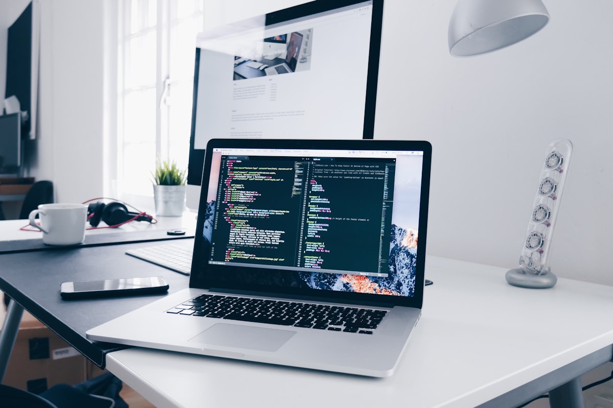 Developer coding a website on a desktop setup